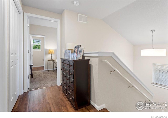 hall with dark hardwood / wood-style flooring and lofted ceiling