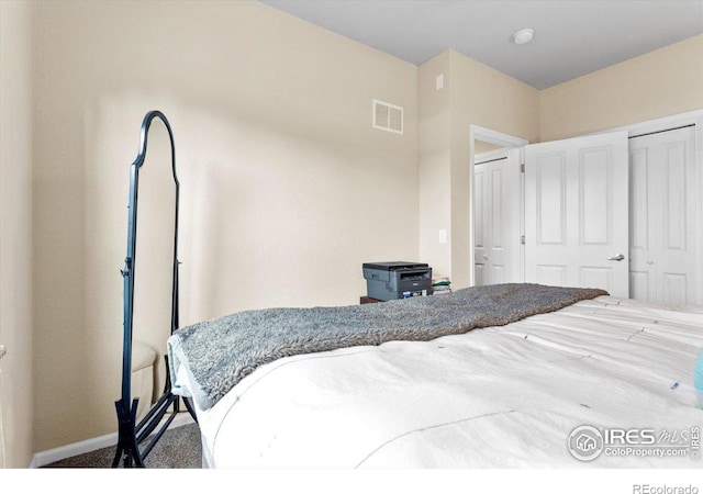 carpeted bedroom with a closet