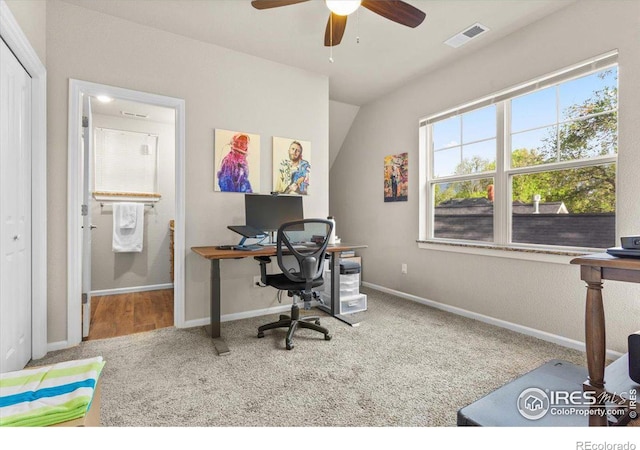 carpeted office featuring ceiling fan and vaulted ceiling