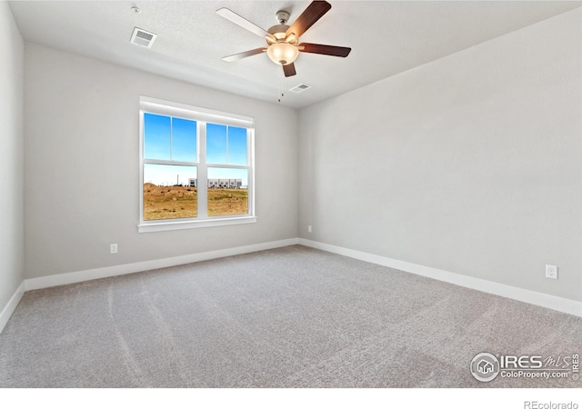 carpeted empty room featuring ceiling fan