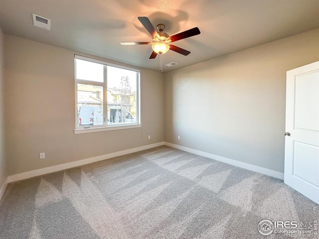 unfurnished room featuring ceiling fan and carpet