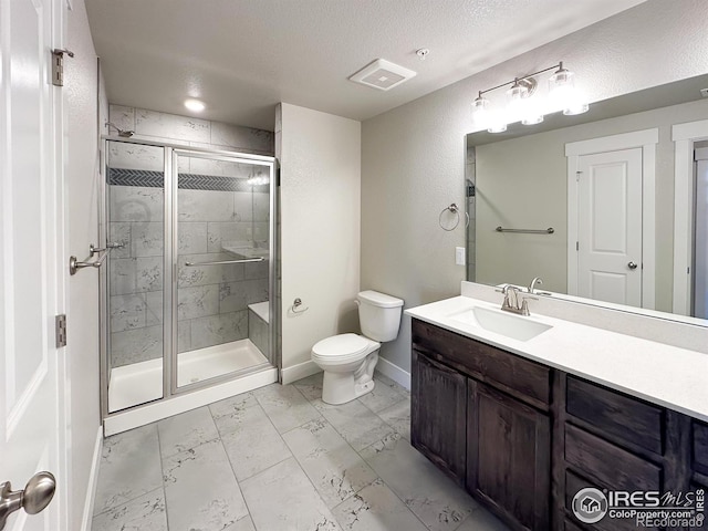 bathroom with vanity, an enclosed shower, a textured ceiling, and toilet