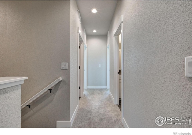 corridor with light colored carpet