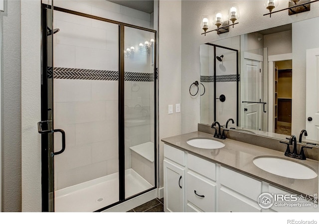 bathroom featuring vanity and an enclosed shower