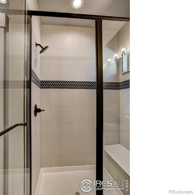 bathroom with tiled shower