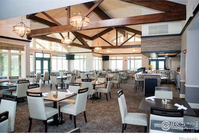 carpeted dining space with a chandelier, beam ceiling, high vaulted ceiling, and french doors