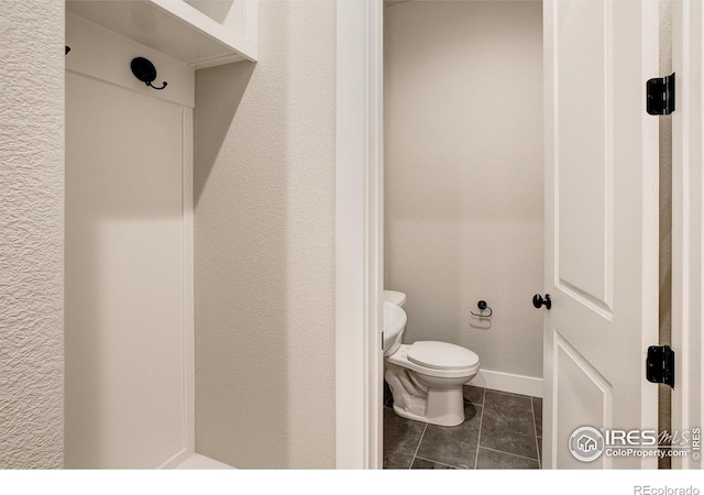 bathroom featuring tile patterned floors and toilet