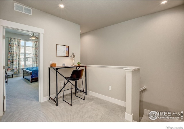 office area featuring ceiling fan and light carpet