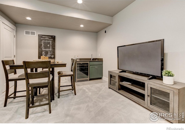 living room featuring bar, light colored carpet, and wine cooler