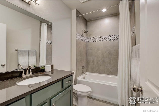 full bathroom featuring tile patterned floors, vanity, toilet, and shower / bath combo with shower curtain