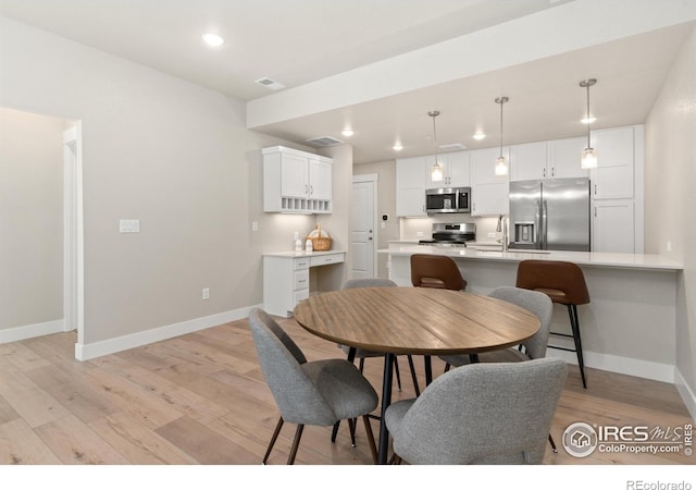 dining space featuring light hardwood / wood-style flooring