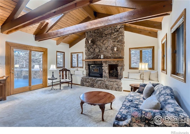 living room featuring carpet flooring, lofted ceiling with beams, a wood stove, and wood ceiling