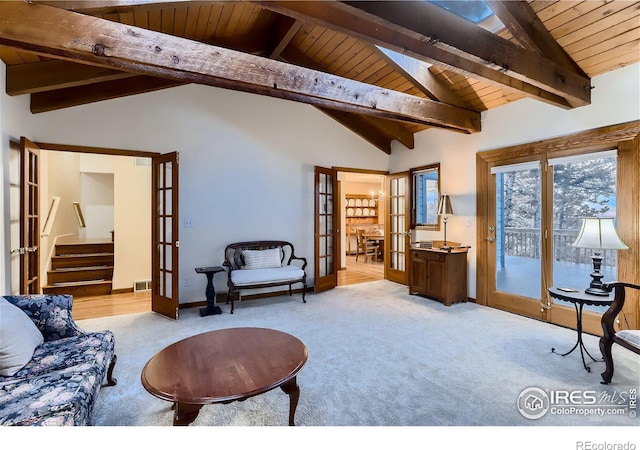 living room featuring lofted ceiling with beams, french doors, light colored carpet, and wooden ceiling