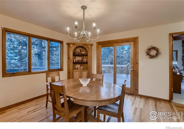 dining space with a chandelier and light hardwood / wood-style flooring