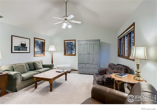 carpeted living room with ceiling fan and lofted ceiling