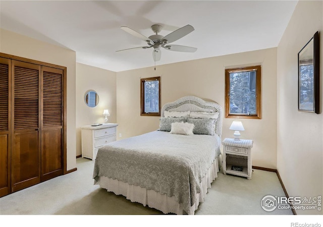 bedroom featuring a closet, ceiling fan, and light colored carpet