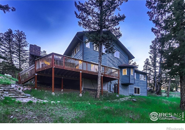 rear view of house with a wooden deck