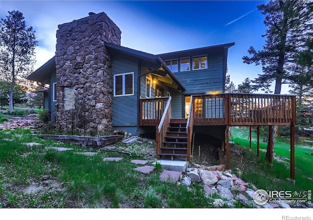 rear view of property featuring a deck