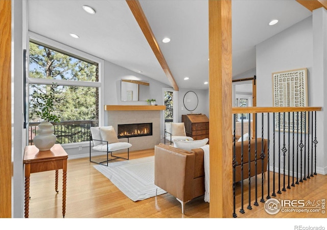 living room with hardwood / wood-style flooring and vaulted ceiling with beams