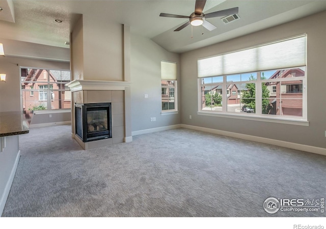 unfurnished living room with a fireplace, light colored carpet, ceiling fan, and lofted ceiling