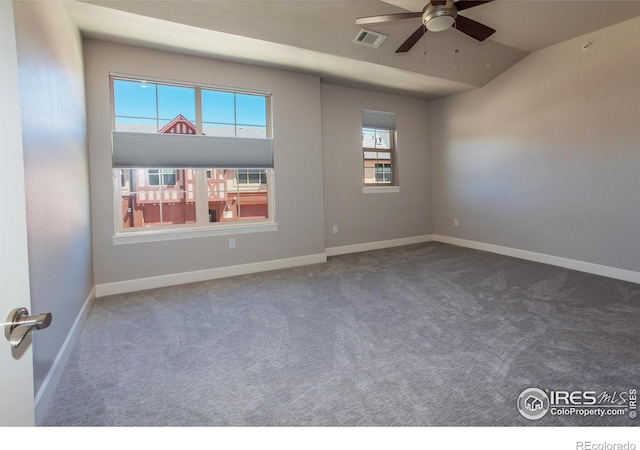 empty room featuring ceiling fan, lofted ceiling, and carpet floors