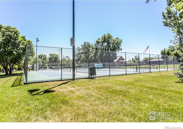 view of sport court featuring a lawn