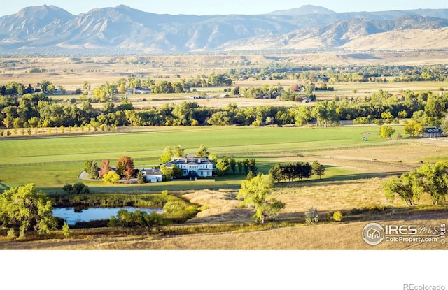 view of mountain feature with a rural view and a water view