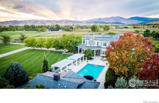 view of pool featuring a mountain view, a pergola, and a rural view