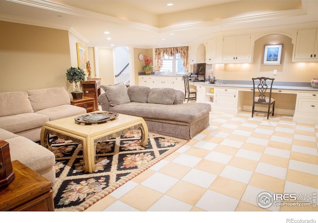 living room featuring built in desk and crown molding