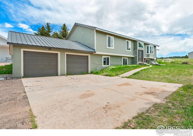 view of front of property with a garage and a front yard