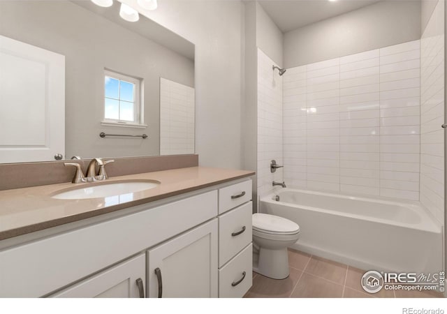 full bathroom featuring tiled shower / bath combo, tile patterned flooring, vanity, and toilet