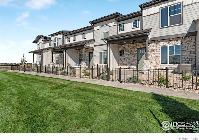 back of property with a lawn and central air condition unit