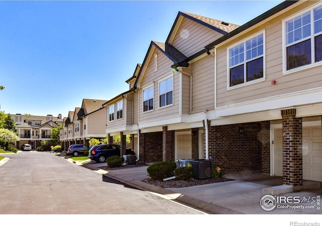 view of front of property with a carport and central air condition unit