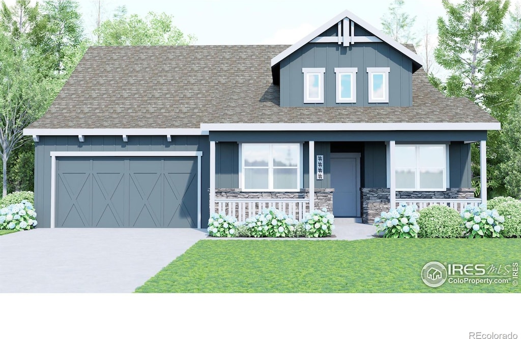 view of front of home featuring a porch, a garage, and a front yard