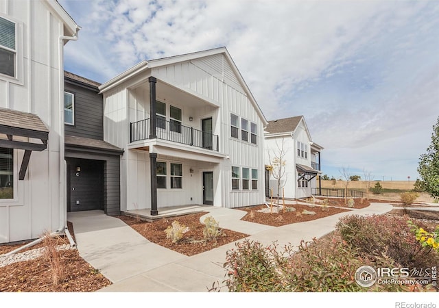 view of front of home with a balcony and a garage