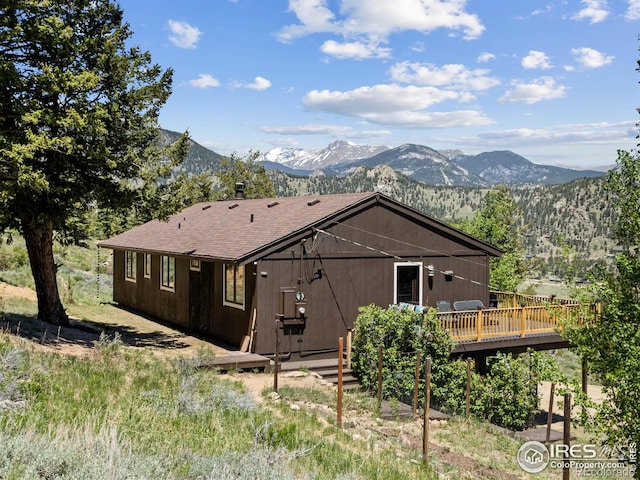 back of house with a deck with mountain view