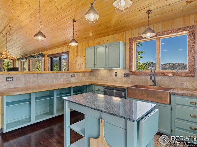 kitchen featuring wood ceiling, plenty of natural light, pendant lighting, and sink