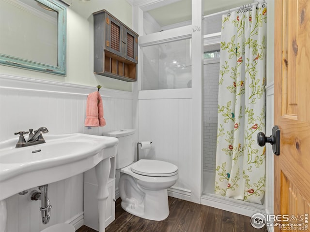 bathroom with toilet, hardwood / wood-style flooring, a shower with shower curtain, and sink