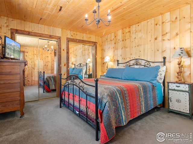 carpeted bedroom featuring a notable chandelier, wooden ceiling, and wooden walls