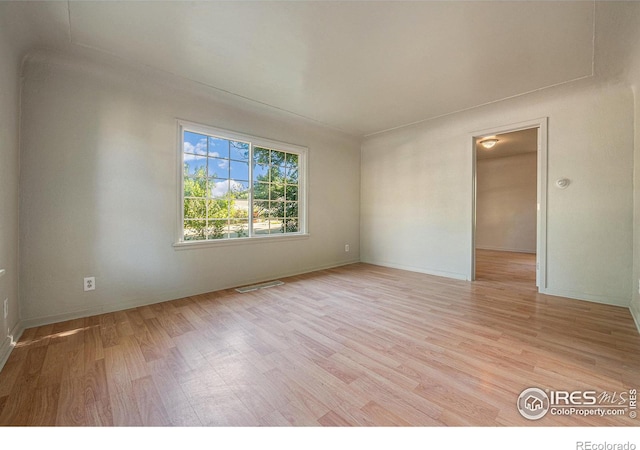 unfurnished room with light hardwood / wood-style flooring