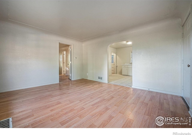 unfurnished room with light wood-type flooring