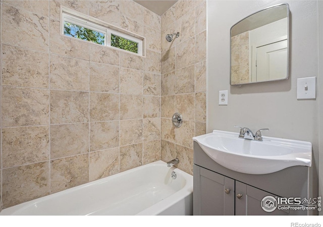 bathroom featuring vanity and tiled shower / bath