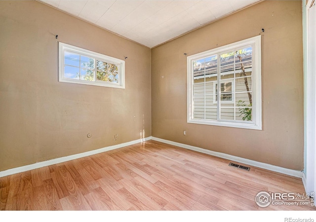 spare room with light wood-type flooring