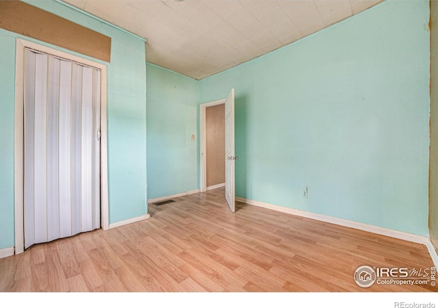 unfurnished bedroom with light wood-type flooring