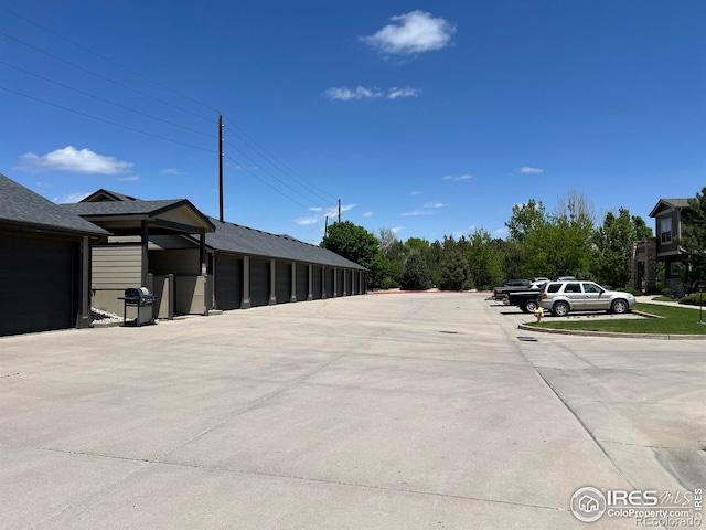 view of vehicle parking featuring a garage