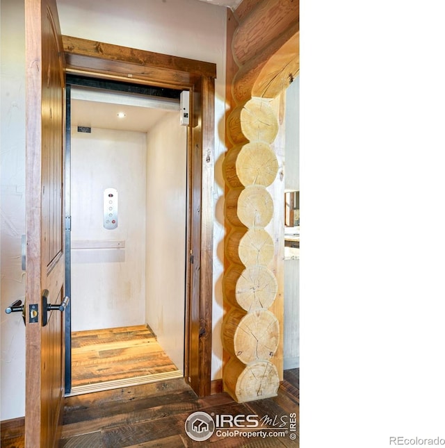 interior space with hardwood / wood-style flooring and elevator