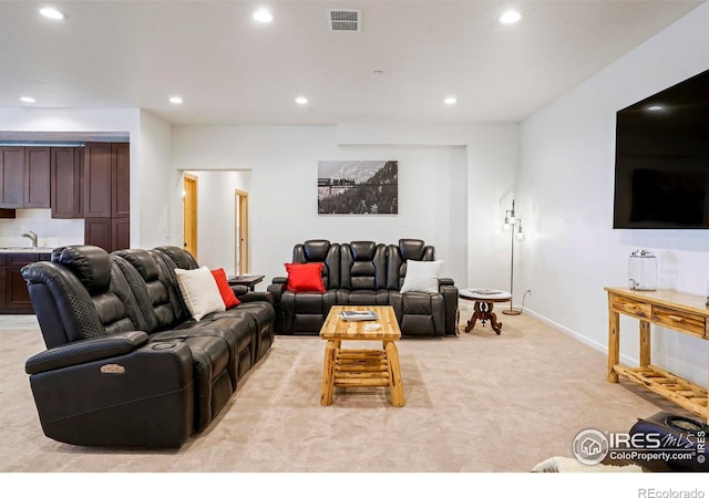 carpeted living room featuring sink