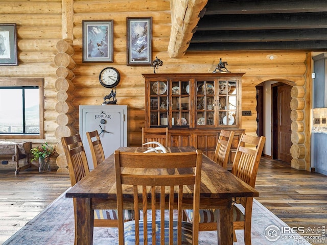 dining area with log walls, dark hardwood / wood-style flooring, and beamed ceiling