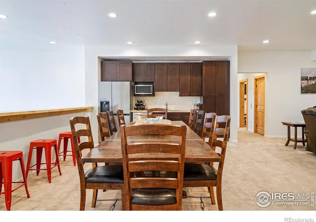 dining room featuring light colored carpet