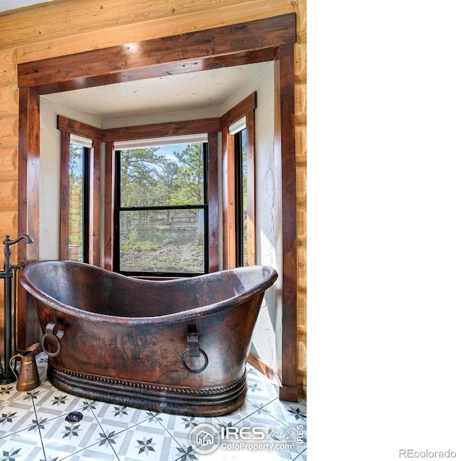 bathroom with tile patterned floors and a bathing tub